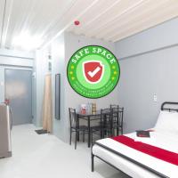 a bedroom with a bed and a green sign on the wall at RedDoorz @ Sunfields Lipa Batangas