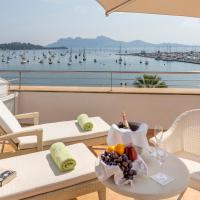 a table with a bowl of fruit on a balcony at Hotel Miramar, Port de Pollensa