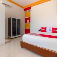 a bedroom with a large bed with red pillows at OYO 3784 Restu Inn, Lampung