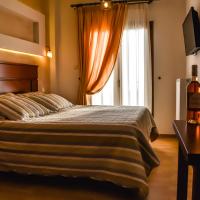 a bedroom with a bed and a table with wine glasses at Tasia Mountain Hotel, Chania
