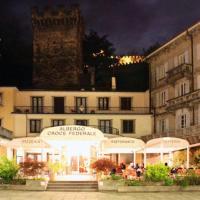 a building with people sitting in front of it at night at Hotel Croce Federale, Bellinzona