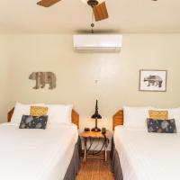 two beds in a room with white walls and windows at Buckeye Tree Lodge, Three Rivers