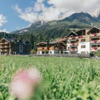 a field of flowers in front of a resort at Boutique Hotel Das Rivus, Leogang