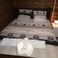 a bed with two pillows and towels on it at Chambre1 Résidence Beauregard, Koungou