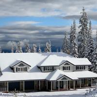 a house covered in snow with snow covered trees at Vacation Homes by The Bulldog - Knight Star Lodge Properties, Silver Star