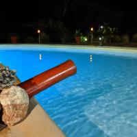 a swimming pool with a baseball bat in the water at Hotel Lakana Ramena, Antsiranana