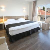 a hotel room with a large bed and a balcony at Centrum Hotel - City Center, Nicosia