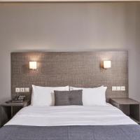 a bedroom with a large bed with two night stands at Mediterranee, Patra