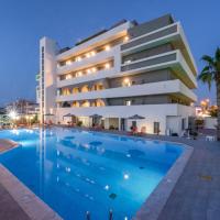 a hotel with a swimming pool in front of a building at Vanisko Hotel, Amoudara Herakliou