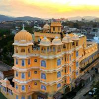 a large yellow building with a dome on top of it at Bloom Boutique l A Heritage Property at Lake Pichola, Udaipur