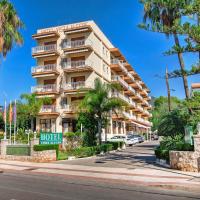 a large apartment building on a street with palm trees at Vista Alegre, Benicàssim