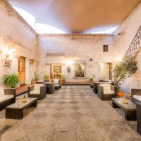 a lobby with couches and tables in a building at Hotel Los Tambos Colonial, Arequipa