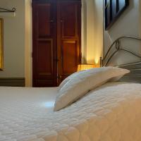 a bed with a white pillow in front of a door at Boutique Hotel Belgica, Ponce