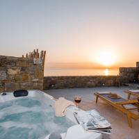 a jacuzzi tub in a room with a table at Gorgeous Studio In Cycladic Architecture Overlooking The Aegean, Houlakia
