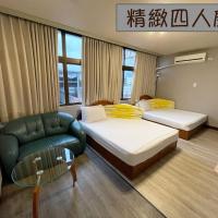 a hotel room with two beds and a chair at Yi Mei Hotel, Jinshan
