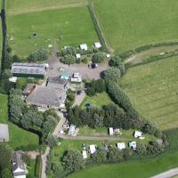 an aerial view of an estate with a house and trees at Sotterum Mobile homes Caravan Tent house Group accommodation, Makkum