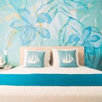 a bedroom with a bed with a blue floral wallpaper at Sea Colors Hotel, San Andrés