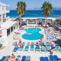 an image of a pool at a resort with people sitting in chairs at Quayside Village Hotel, Kavos