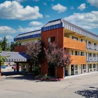 a large brick building with a parking lot at Olympic Inn & Suites Port Angeles