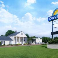 a days inn sign in front of a house at Days Inn by Wyndham Natchez