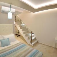 a room with a staircase and a bed and a desk at Agios Gordios Beach Resort