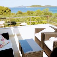 a balcony with wicker chairs and a table and the ocean at Holiday Home Subasic, Zlarin