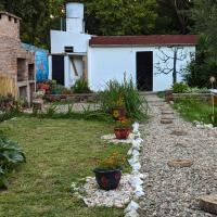 a garden with plants and flowers in a yard at Hostel El Refugio de Las Aves, Santa Rosa de Calamuchita