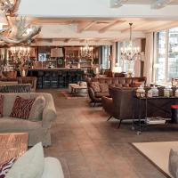 a living room with couches and a bar at Q! Hotel Maria Theresia, Kitzbühel