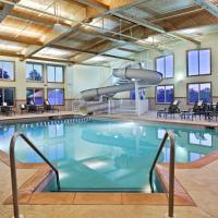 a large indoor pool with chairs and tables at Country Inn & Suites by Radisson, Galena, IL