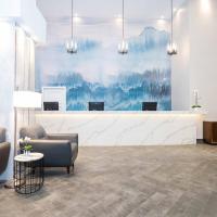 a lobby with two chairs and a waiting room at Sandman Signature Calgary Downtown Hotel