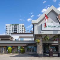 a building with a welcome sign on the front of it at Sandman Hotel & Suites Kelowna