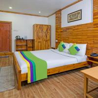 a bedroom with a bed and a wooden wall at Treebo Trend Omega Stay Inn Shillong