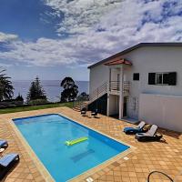 a swimming pool in front of a house at Villa Prainha by MHM, Caniçal