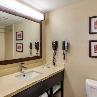 a bathroom with a sink and a mirror and a toilet at Comfort Inn & Suites near Six Flags, Lithia Springs