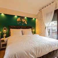 a bedroom with a large bed with a green wall at Villa Park Plitvice, Rakovica