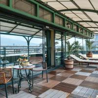 a balcony with chairs and tables on a building at Grand Hotel Sofia - Top Location, The Most Spacious Rooms in the City, Secured Underground Parking