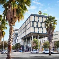 a hotel with palm trees in front of a street at B&B HOTEL Barcelona Mataro, Mataró