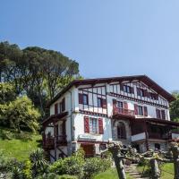 a house on a hill with trees in front of it at Hotel Bellevue, Hendaye