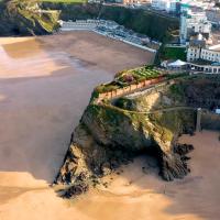 an aerial view of a cliff next to the beach at Great Western, Newquay