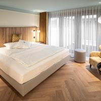 a bedroom with a large bed and a chair at Best Western Plus Hotel Bern