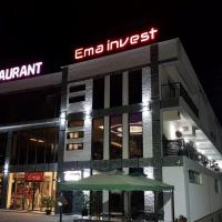 a building with a sign on top of it at night at HOTEL EMA, Tetovo