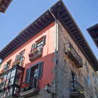 a building with windows and balconies on a street at Hotel Palacio Oxangoiti, Lekeitio