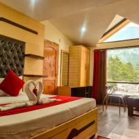 a bedroom with a bed and a window with a view at Hotel Mountain Top, Manāli