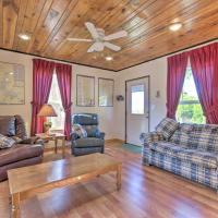 a living room with furniture and a ceiling fan at Henderson Getaway 1 Block to Norfork Lake!