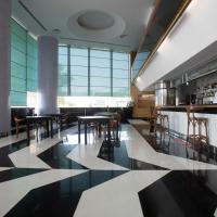 a restaurant with black and white floors and tables at Grand Hotel Salerno