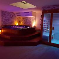 a room with a stone wall and a room with stairs at Suite room jacuzzi sauna privatif illimité Clisson