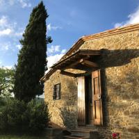 an old stone house with a wooden door at Podere Pruneto, Radda in Chianti