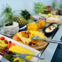 a buffet of fruit and vegetables on a table with scissors at Aparthotel Miramare, Makarska