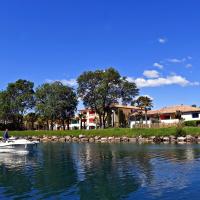 a man in a boat on a river with houses at Hotel Casarose - Cannes Mandelieu, Mandelieu-La Napoule