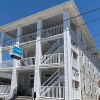 a white apartment building with a large balcony at Oakview Hotel, Wildwood